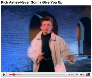 Vintage YouTube player titled "Rick Astley-Never Gonna Give You Up" showing a singer in a beige trench coat dancing in a brick archway