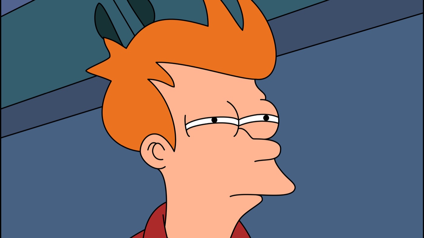 Close-up of a squinting, suspicious Fry from Futurama with narrowed eyes