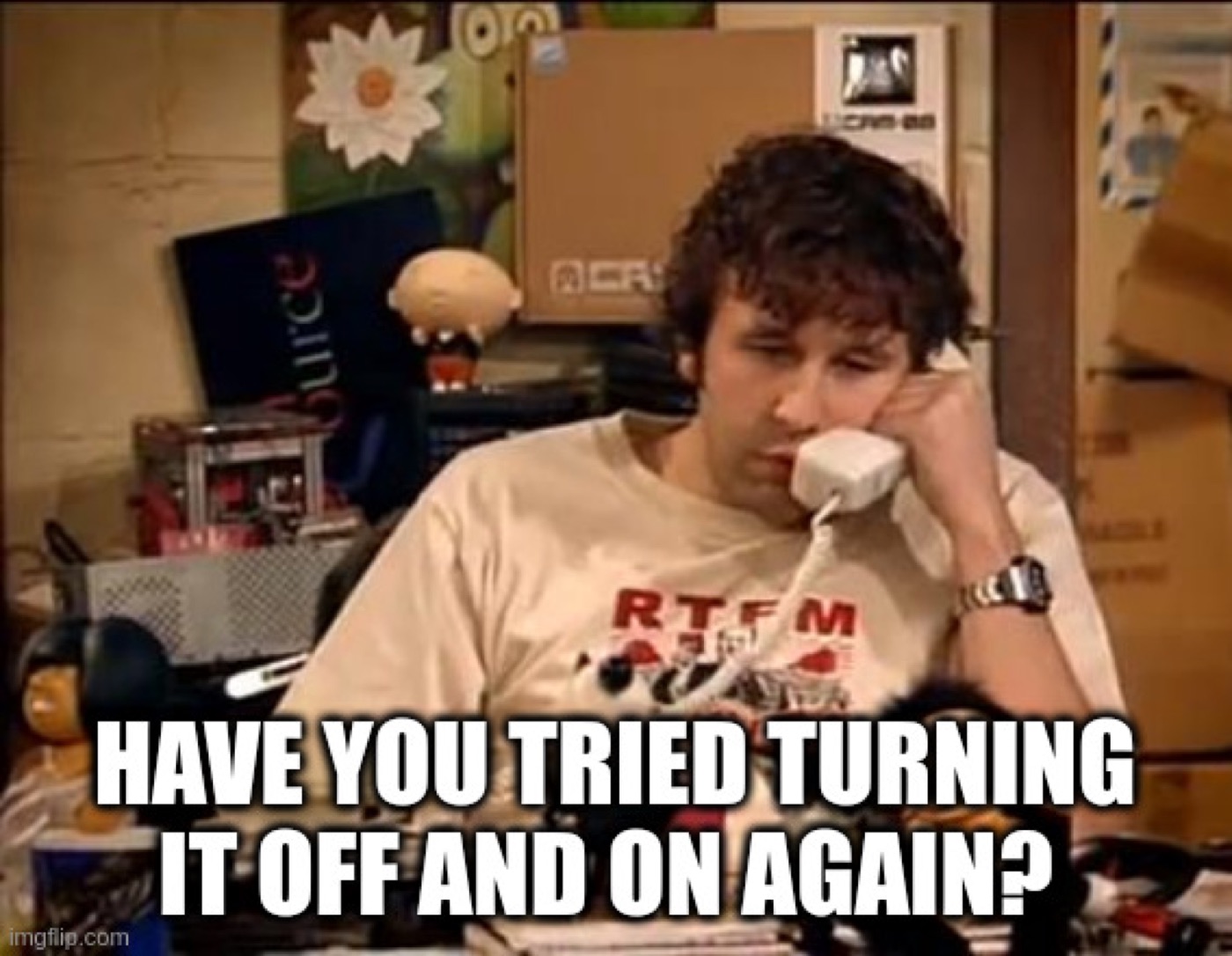 Roy from The IT Crowd answering a phone with the line "have you tried turning it off and on again?"