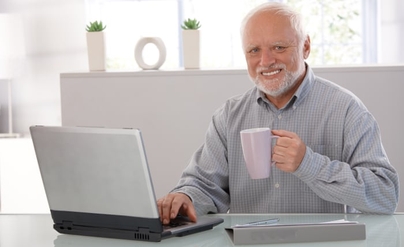 An older man with a strained, pained smile