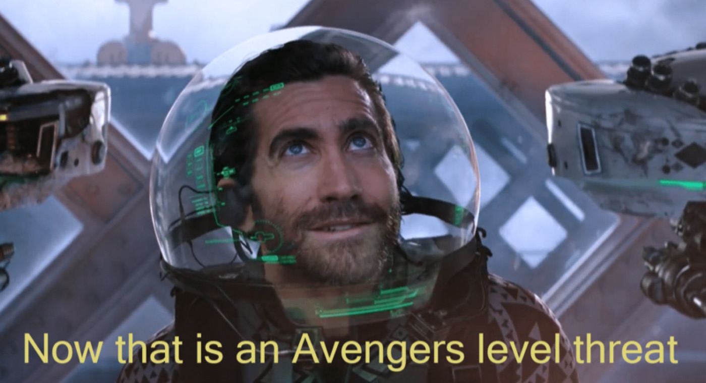 Bearded man in a glass-domed spacesuit helmet looking up inside a spacecraft, subtitled "Now that is an Avengers level threat"