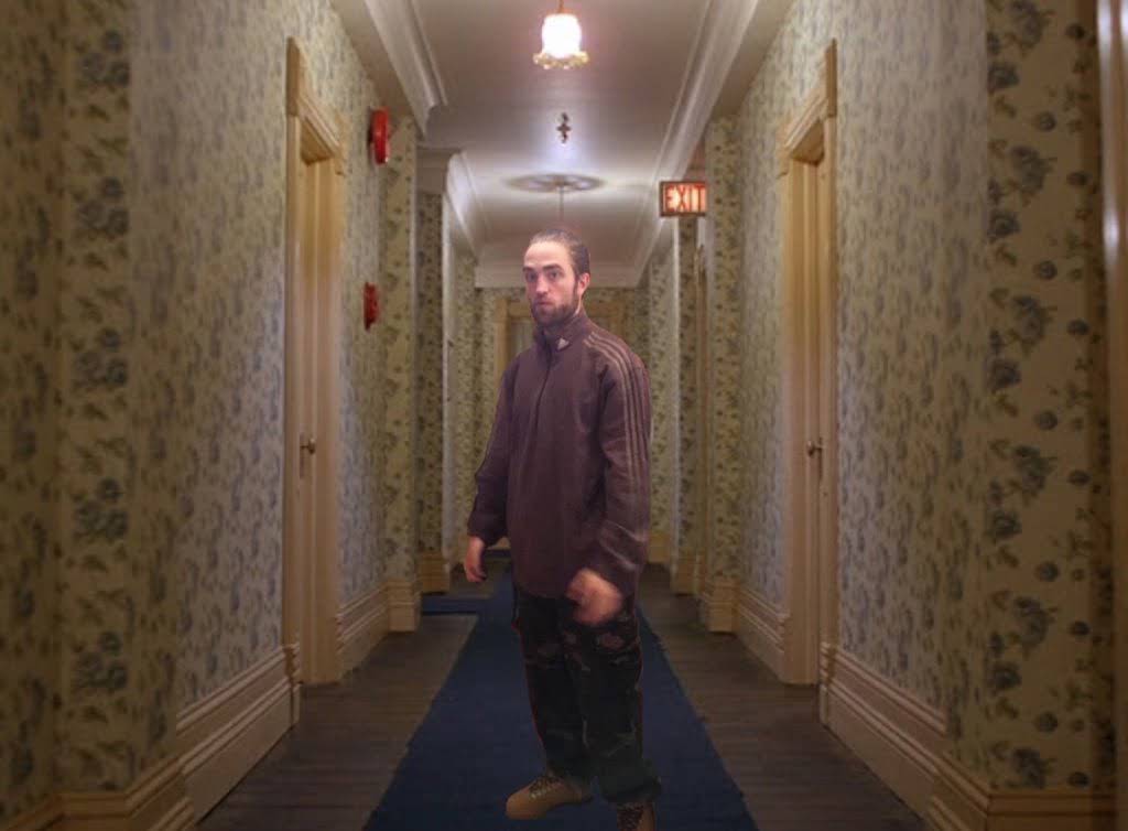 A figure standing awkwardly in a tracksuit, Robert Pattinson meme style
